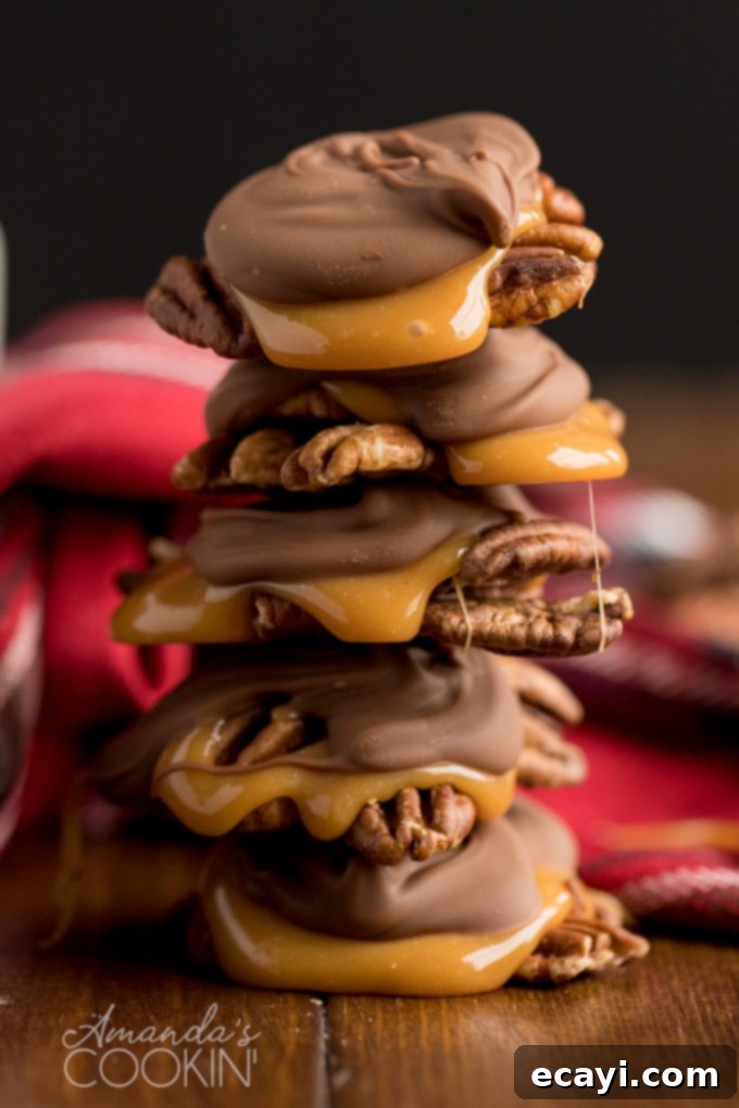 Homemade chocolate turtles are crunchy and chewy, salty and sweet, perfect as an edible gift. Featuring toasted pecans, soft, chewy caramel, and delicious chocolate. Stacked homemade chocolate turtles with a sprinkle of sea salt