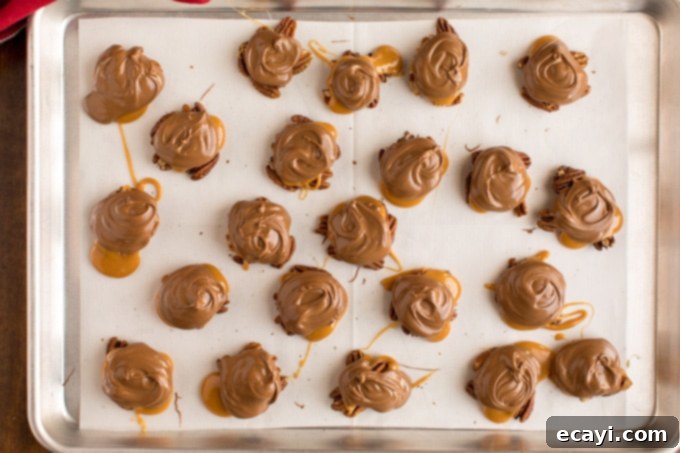 Delicious homemade turtle candy in a pan, featuring crunchy pecans, gooey caramel, and smooth chocolate. A baking pan filled with freshly made homemade chocolate turtles