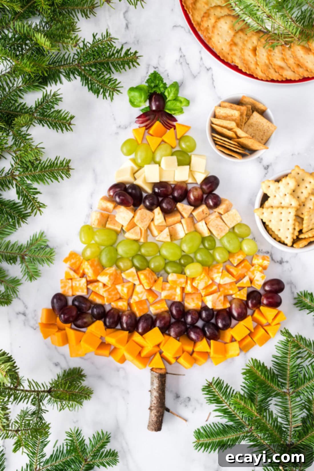 Festive Cheese Tree Board 2 Overhead photo of a Christmas Tree Cheese Platter artfully arranged with cheeses and grapes