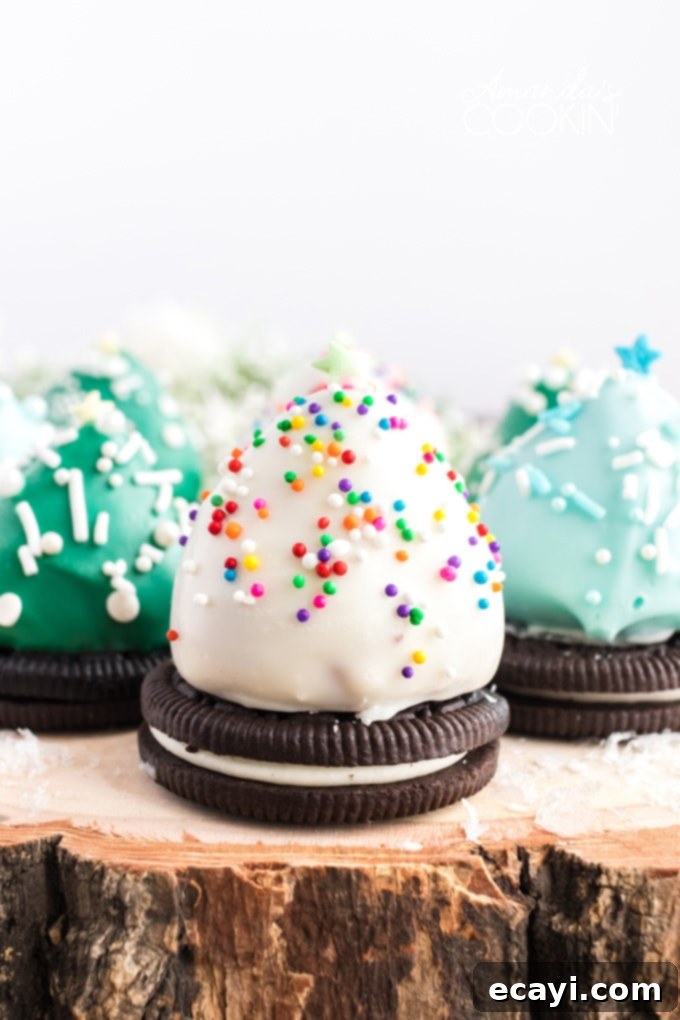 Chocolate covered Strawberry Christmas Trees have an Oreo cookie base, perfect finger food. Delicious strawberries look like festive little Christmas trees! chocolate covered strawberry christmas trees on a wood platter