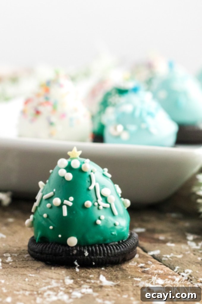 Chocolate covered Strawberry Christmas Trees have an Oreo cookie base, perfect finger food. Delicious strawberries look like festive little Christmas trees! tray of christmas tree treats made from strawberries