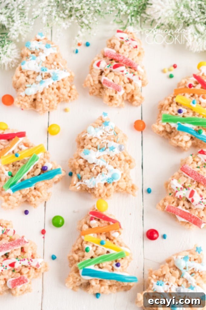 Make Christmas Tree Rice Krispie Treats with the kids. Rice Krispies, marshmallows, and candy decorations make adorable Christmas trees! rice krispie treats shaped like christmas trees