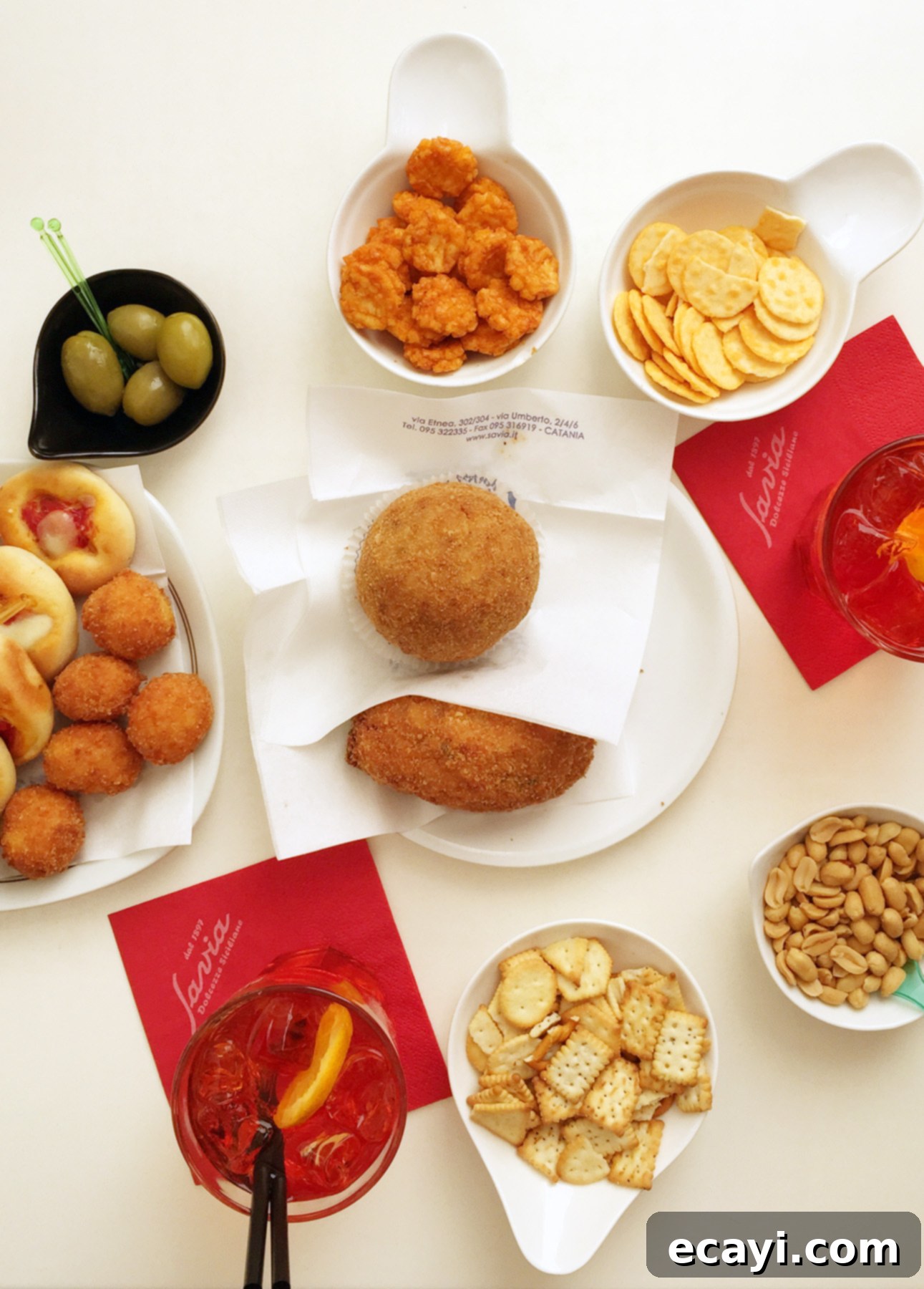Mastering Authentic Sicilian Arancini 5 A classic aperitivo spread of snacks featuring arancini in Catania, Sicily // FoodNouveau.com