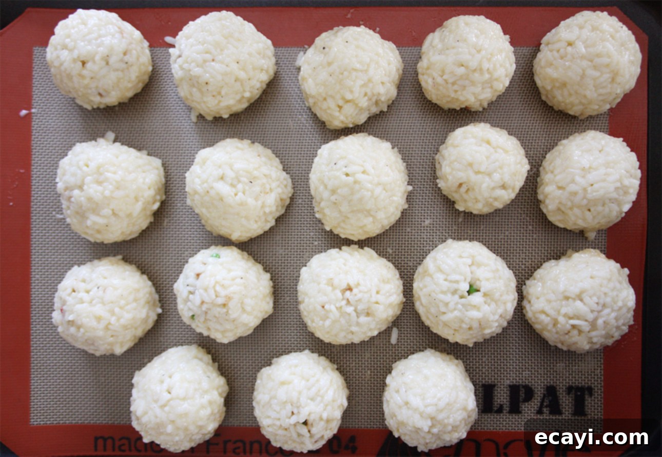 Mastering Authentic Sicilian Arancini 6 Arancini (Sicilian risotto balls) before being dredged into breadcrumbs and fried // FoodNouveau.com