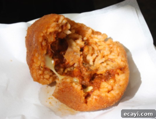Mastering Authentic Sicilian Arancini 8 Inside an arancini, rich ragù sauce and melting cheese await (Catania, Sicily)
