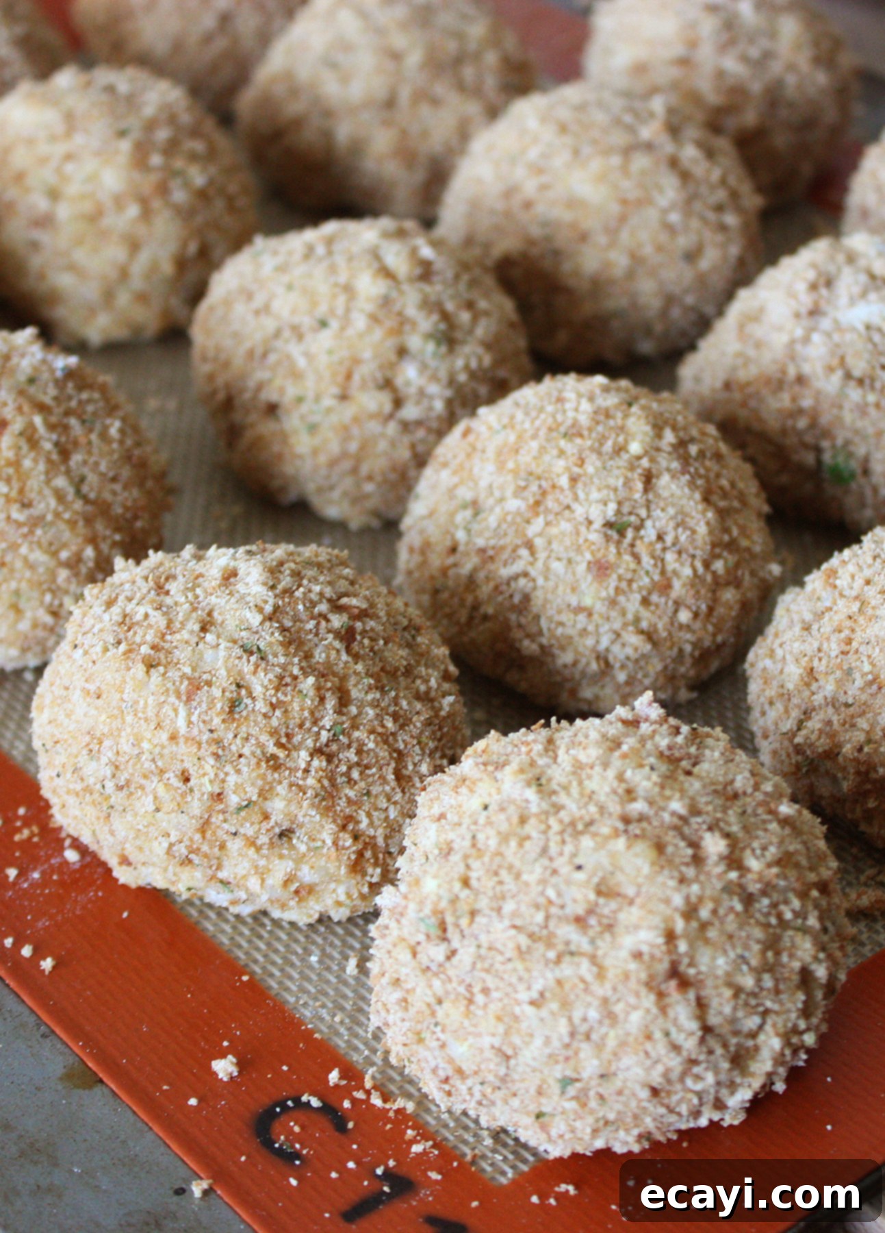 Mastering Authentic Sicilian Arancini 9 Shaped arancini (Sicilian risotto balls), ready to be deep-fried // FoodNouveau.com