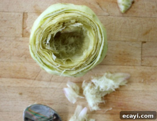 Removing Artichoke Choke Step 5: Scooping out the fuzzy choke from the artichoke heart