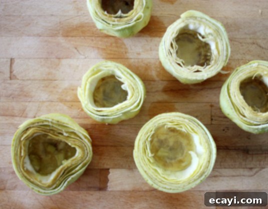 Lemon Juice for Artichokes Step 6: Rubbing a prepared artichoke with lemon to prevent browning