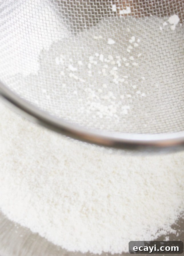 Bake Perfect French Macarons A Visual Masterclass 4 Sieving almond flour and powdered sugar to make French macarons // FoodNouveau.com