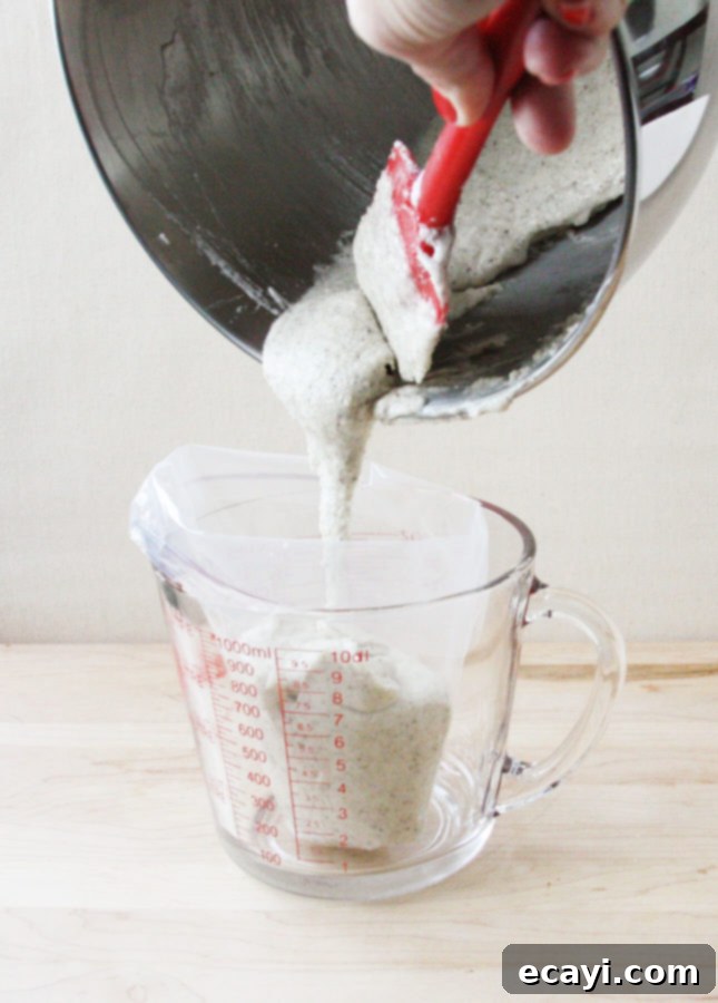 Bake Perfect French Macarons A Visual Masterclass 8 Transferring French macaron batter to a pastry bag for piping // FoodNouveau.com