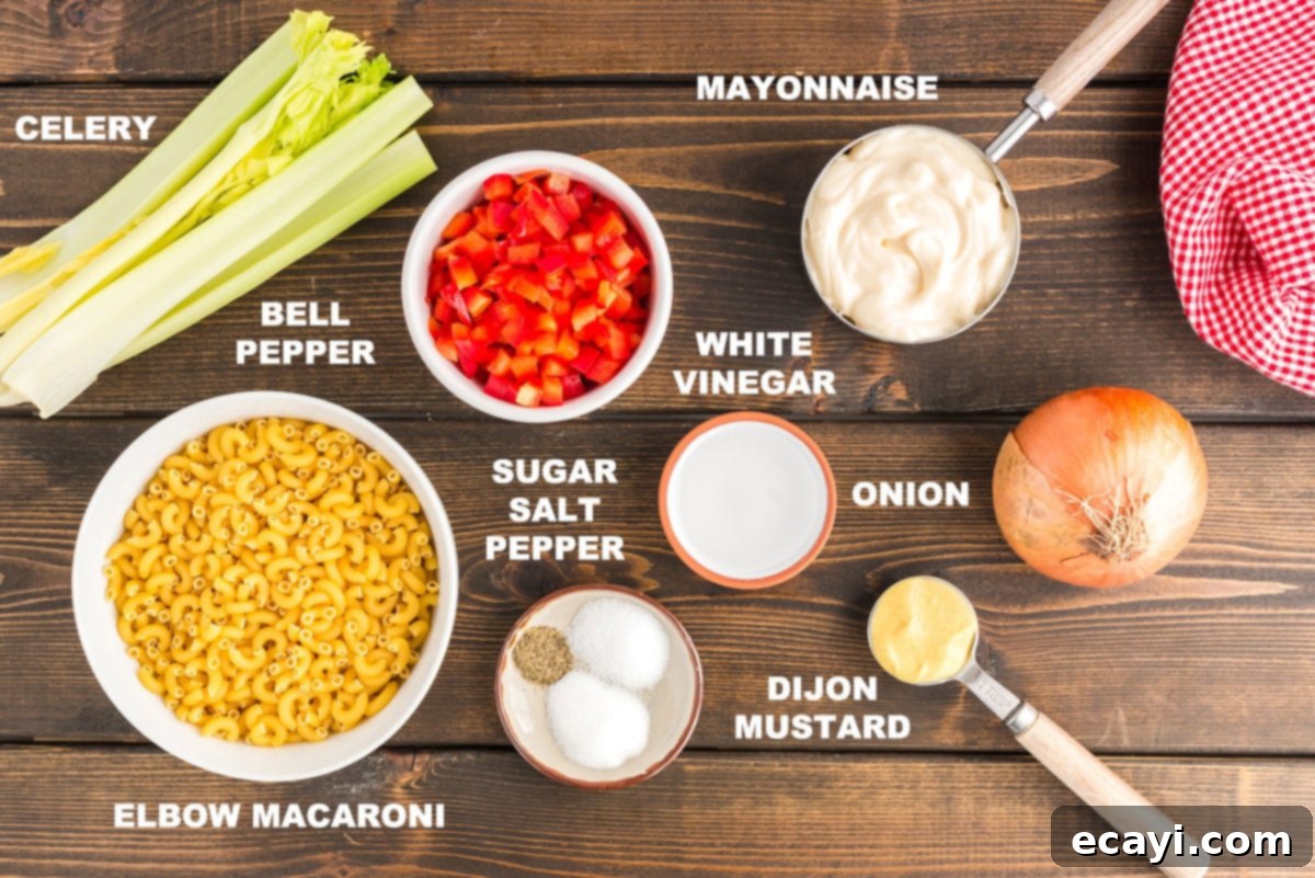 Nana's Homestyle Macaroni Salad 2 A collection of labeled ingredients including mayonnaise, elbow macaroni, celery, bell pepper, and onion, neatly arranged for Nana's macaroni salad recipe preparation.