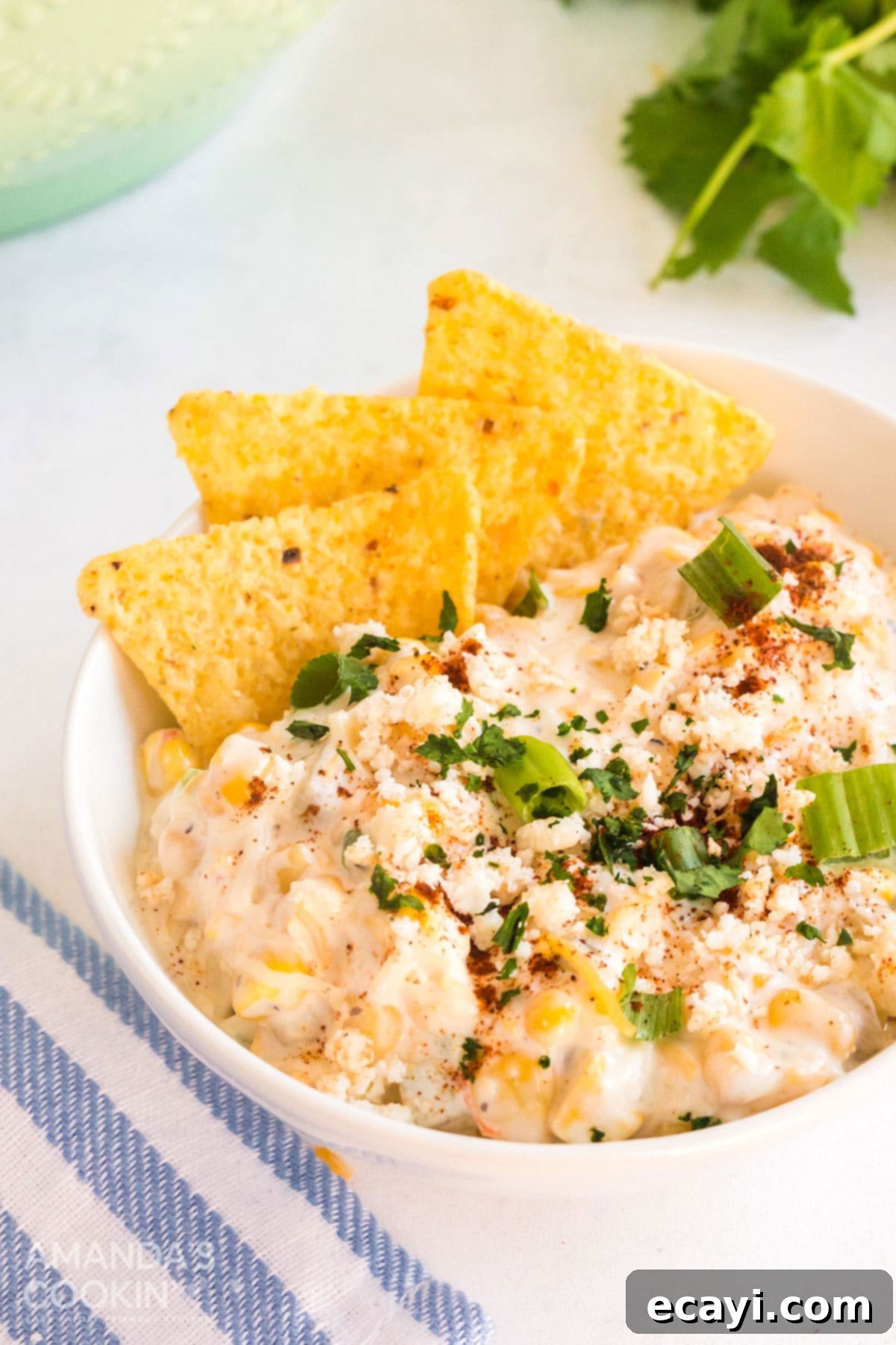 Fiesta Corn Dip 3 Bowl of creamy corn dip generously topped with tortilla chips, ready for serving