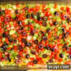 Ultimate Taco Dip 10 taco dip, featuring colorful layers and fresh toppings