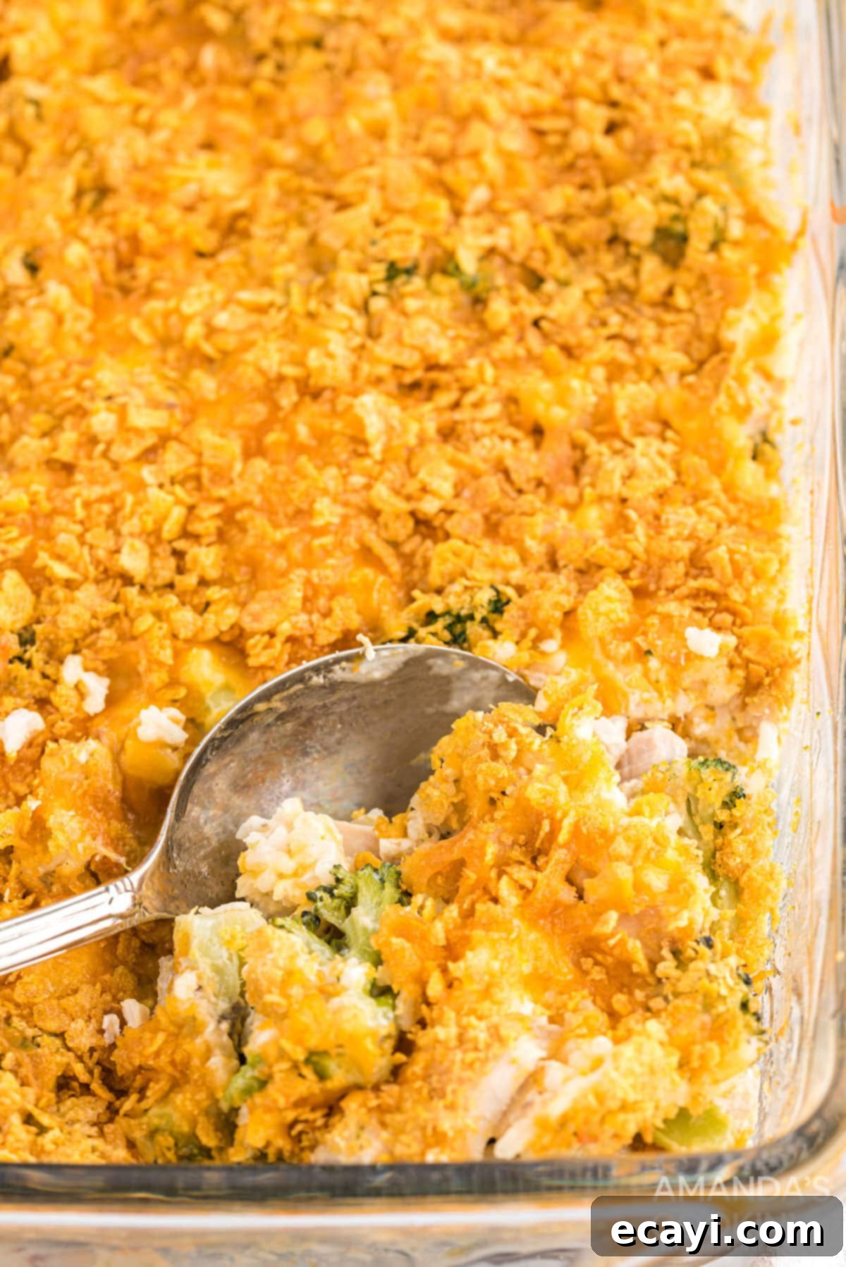 Pure comfort food, this Chicken Broccoli Rice Casserole uses only 8 ingredients, and 40 minutes is all you need to put this delicious dinner on the table. Creamy Chicken Broccoli Rice Casserole with a serving spoon