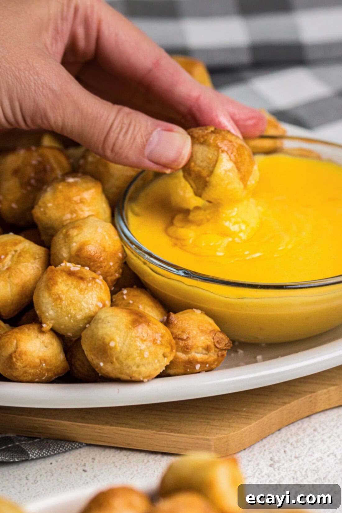 Perfectly Poppable Air Fried Pretzels 3 Air Fryer Pretzel Bite being dipping into cheese sauce