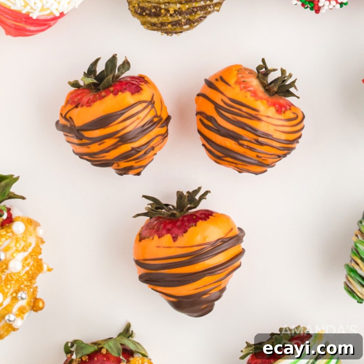 Ideal for any autumn event, these chocolate covered strawberries are a delicious and pretty treat. Three perfectly dipped orange and brown chocolate covered strawberries, ready for a fall celebration