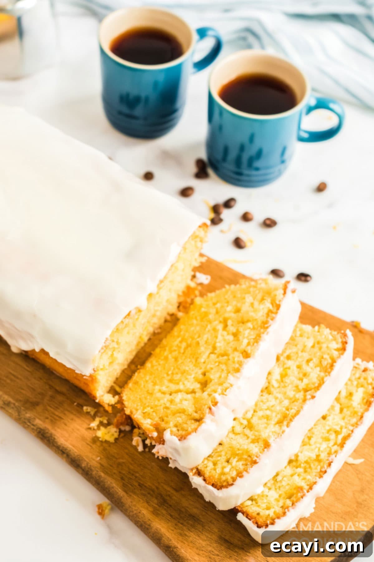 Make the famous Starbucks lemon loaf in your own kitchen. Great for breakfast with coffee, as a snack, or for dessert! sliced lemon loaf on a cutting board