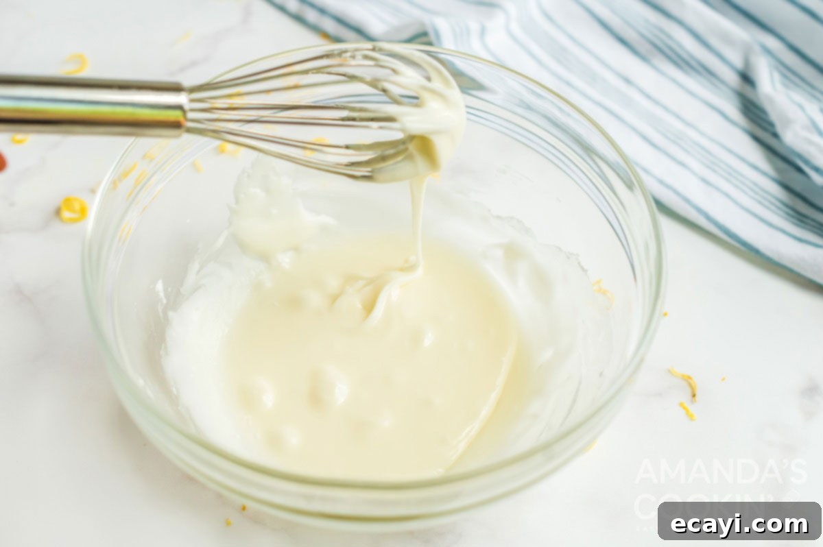 Starbucks Zesty Lemon Loaf 10 glaze dripping off whisk