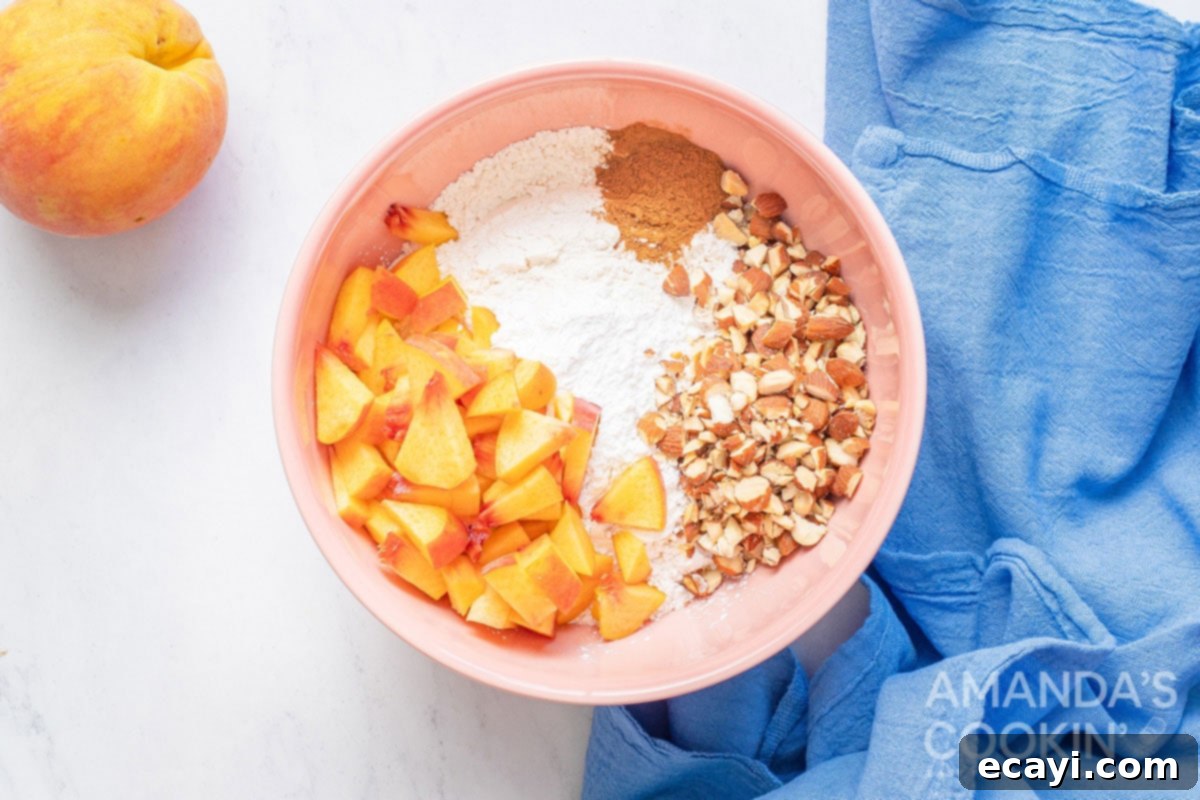 Golden Peach Loaf 4 Various peach bread ingredients, including flour, spices, chopped peaches, and almonds, gathered in separate bowls, ready to be combined into the batter.