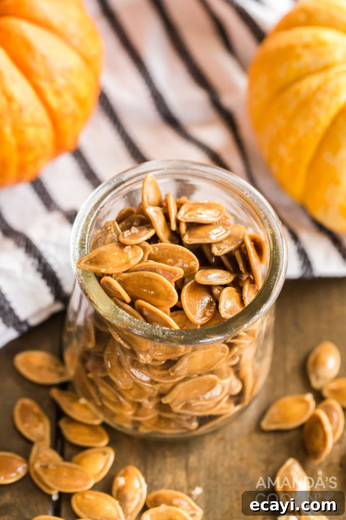 Storing freshly roasted pumpkin seeds in a jar A charming glass jar filled with a large quantity of homemade roasted pumpkin seeds, perfect for storage or sharing.