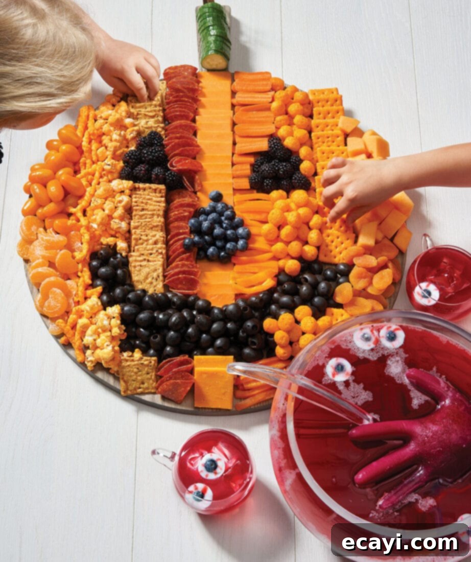 Monster Munchies 2 Jack-o'-lantern shaped charcuterie board with various snacks