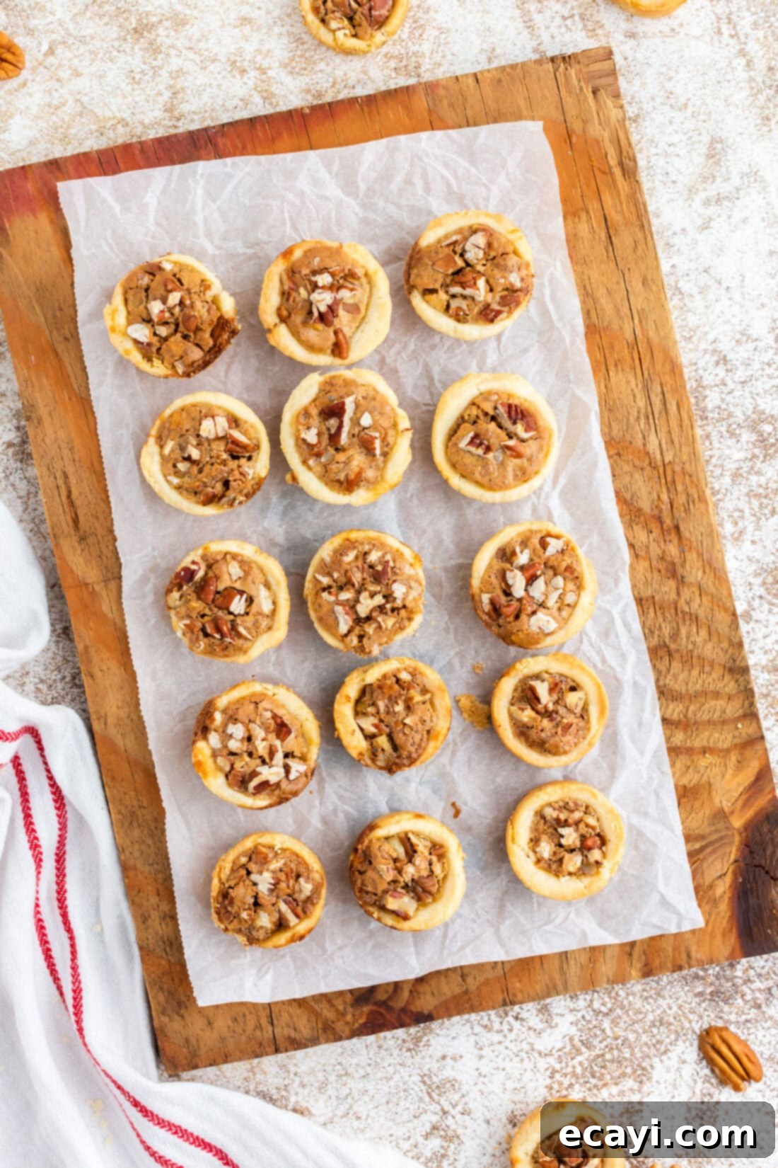 Bite-Sized Pecan Delights 14 pecan tassies on a cutting board