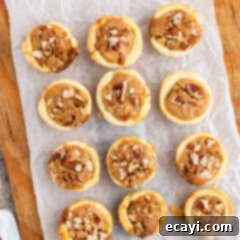 Bite-Sized Pecan Delights 15 pecan tassies on a wood cookie boards