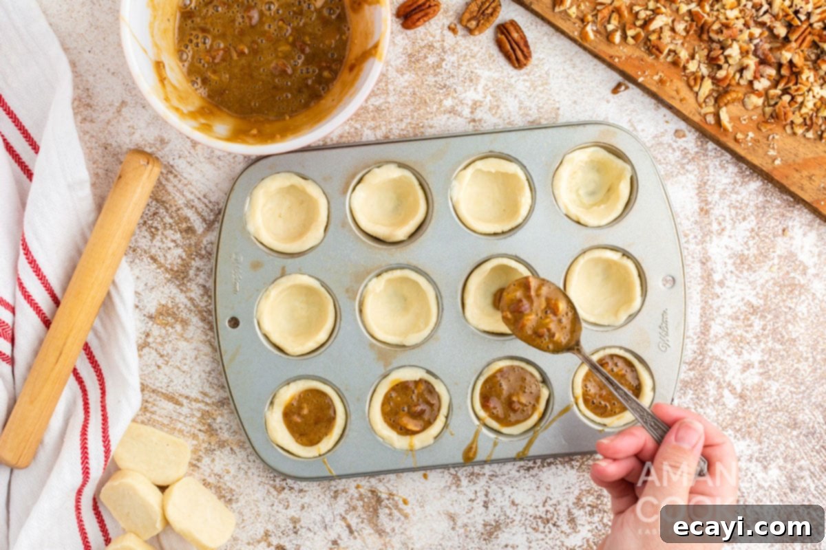 Bite-Sized Pecan Delights 10 spooning filling into dough in muffin tin