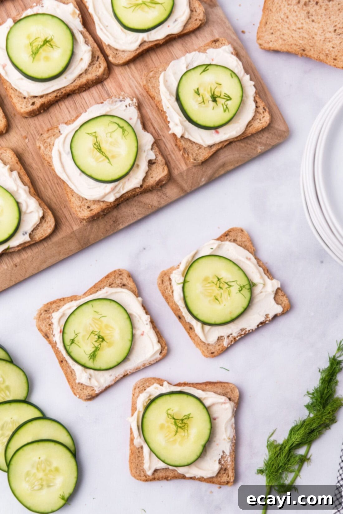 Delicate Cucumber Finger Sandwiches 2 Delightful mini cucumber sandwiches artfully arranged on a rustic wooden board, ready to be served as an appetizer.