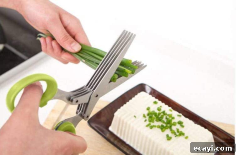 21 Kitchen Gadgets You'll Reach For Daily 11 Herb scissors are used to precisely cut fresh chives, showcasing their effectiveness for quick and even chopping.