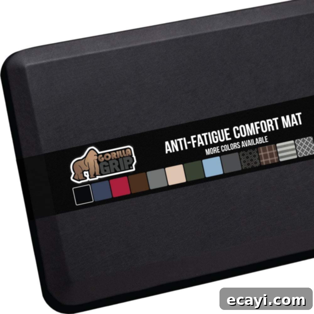 21 Kitchen Gadgets You'll Reach For Daily 20 A black anti-fatigue comfort mat laid on a kitchen floor, promising relief for prolonged standing.