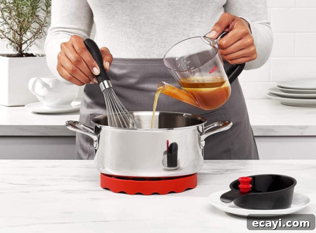 21 Kitchen Gadgets You'll Reach For Daily 8 A fat separator in action, with savory broth pouring out from the bottom while the separated fat remains on top.