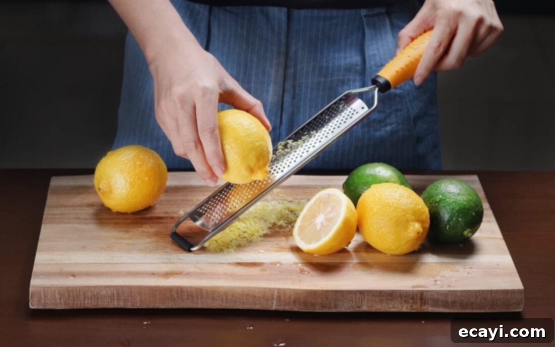 21 Kitchen Gadgets You'll Reach For Daily 9 A hand zesting a fresh lemon with a micro-planer, producing fine aromatic zest for cooking or baking.