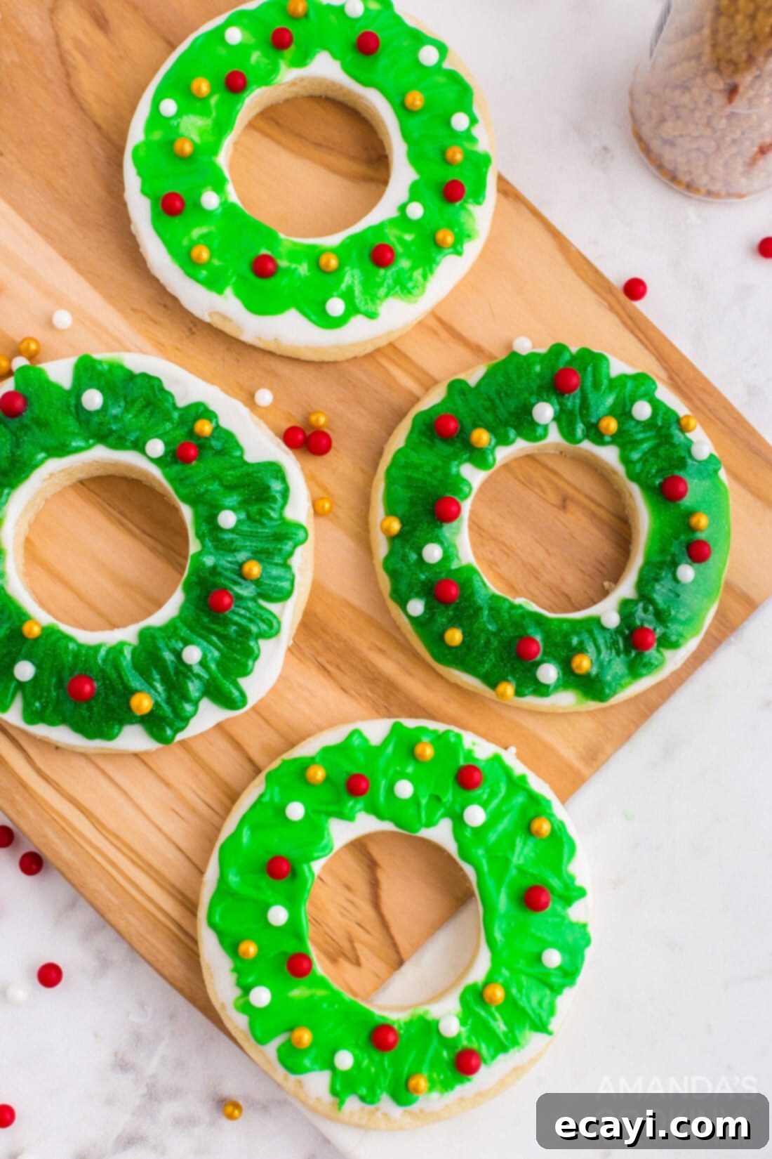 Sweet & Simple Decorated Cookies 19 Round sugar cookies shaped into wreaths, decorated with green sparkle gel and red, white, and gold dragees.