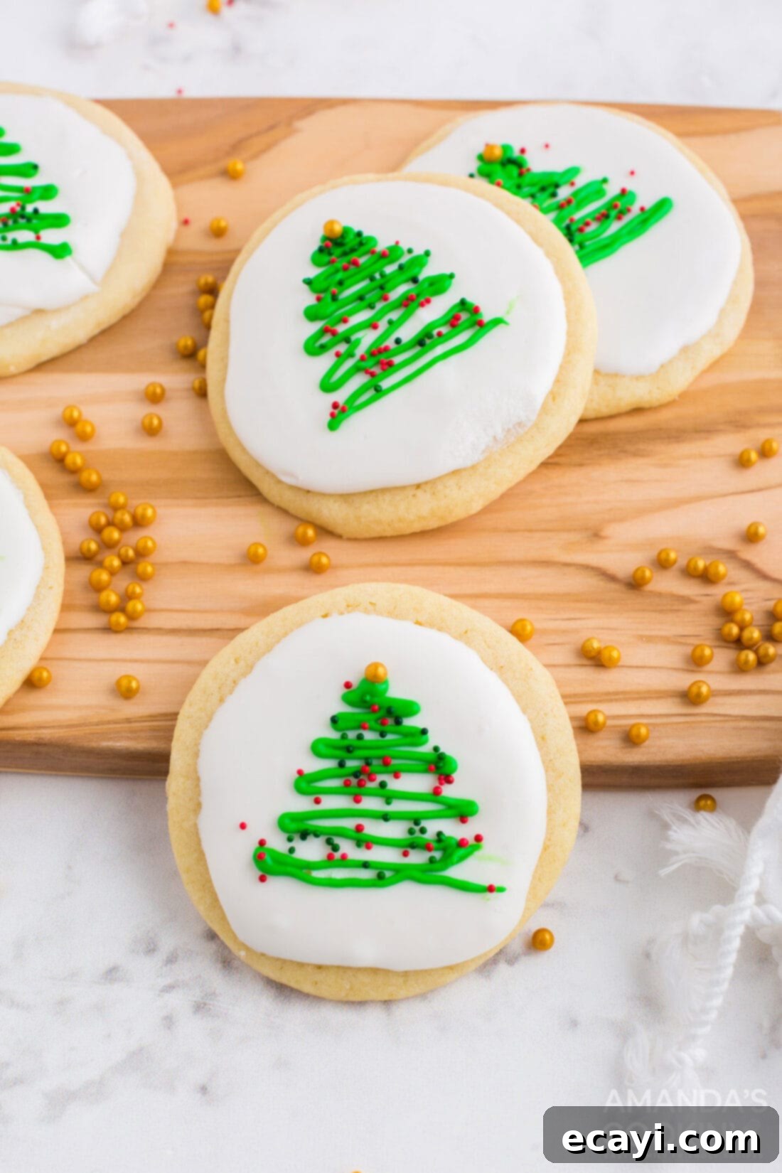 Sweet & Simple Decorated Cookies 6 Round sugar cookies decorated as Christmas trees with green icing writer, red and green nonpareils, and gold star sprinkles.