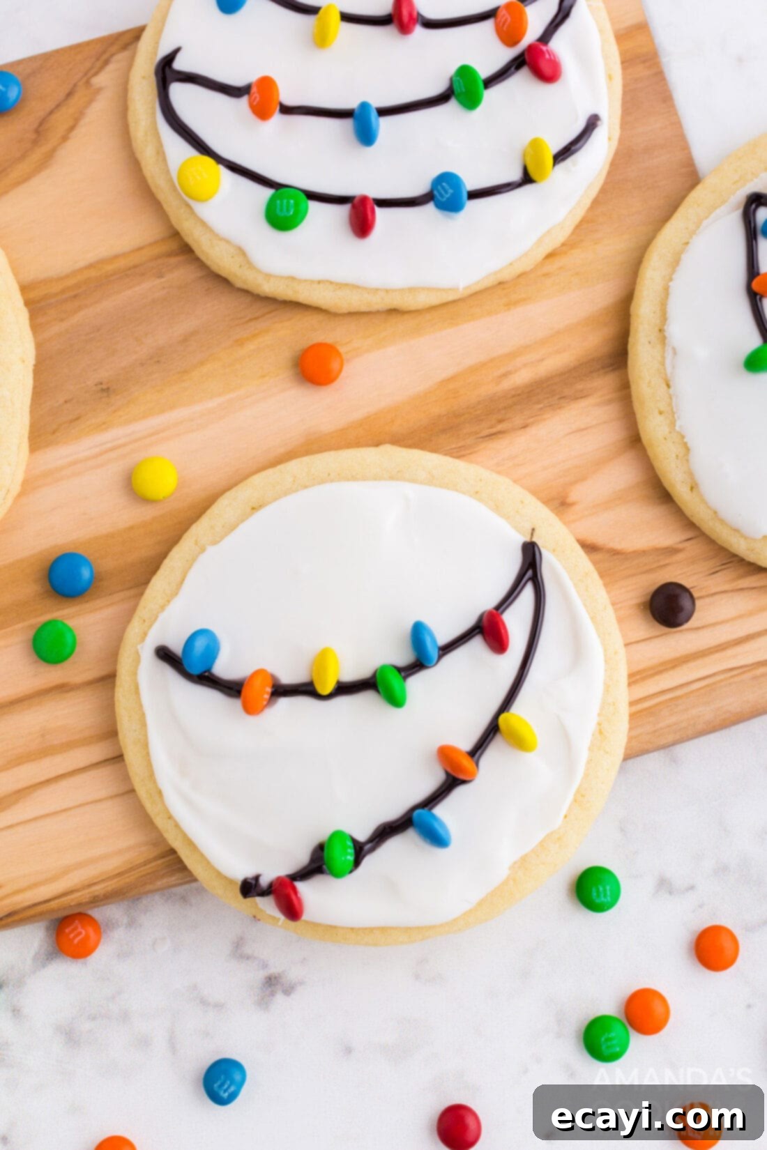 Sweet & Simple Decorated Cookies 8 Round sugar cookies decorated to resemble Christmas string lights, with black gel outlines and colorful mini M&Ms.