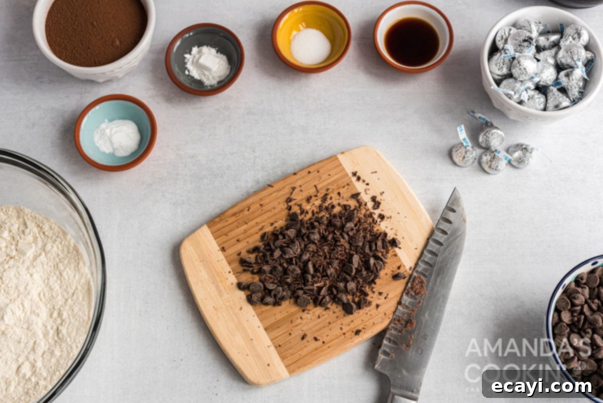 Cozy Cocoa Cookies 5 Finely chopped chocolate chips on a wooden cutting board, ready to be used as a garnish.
