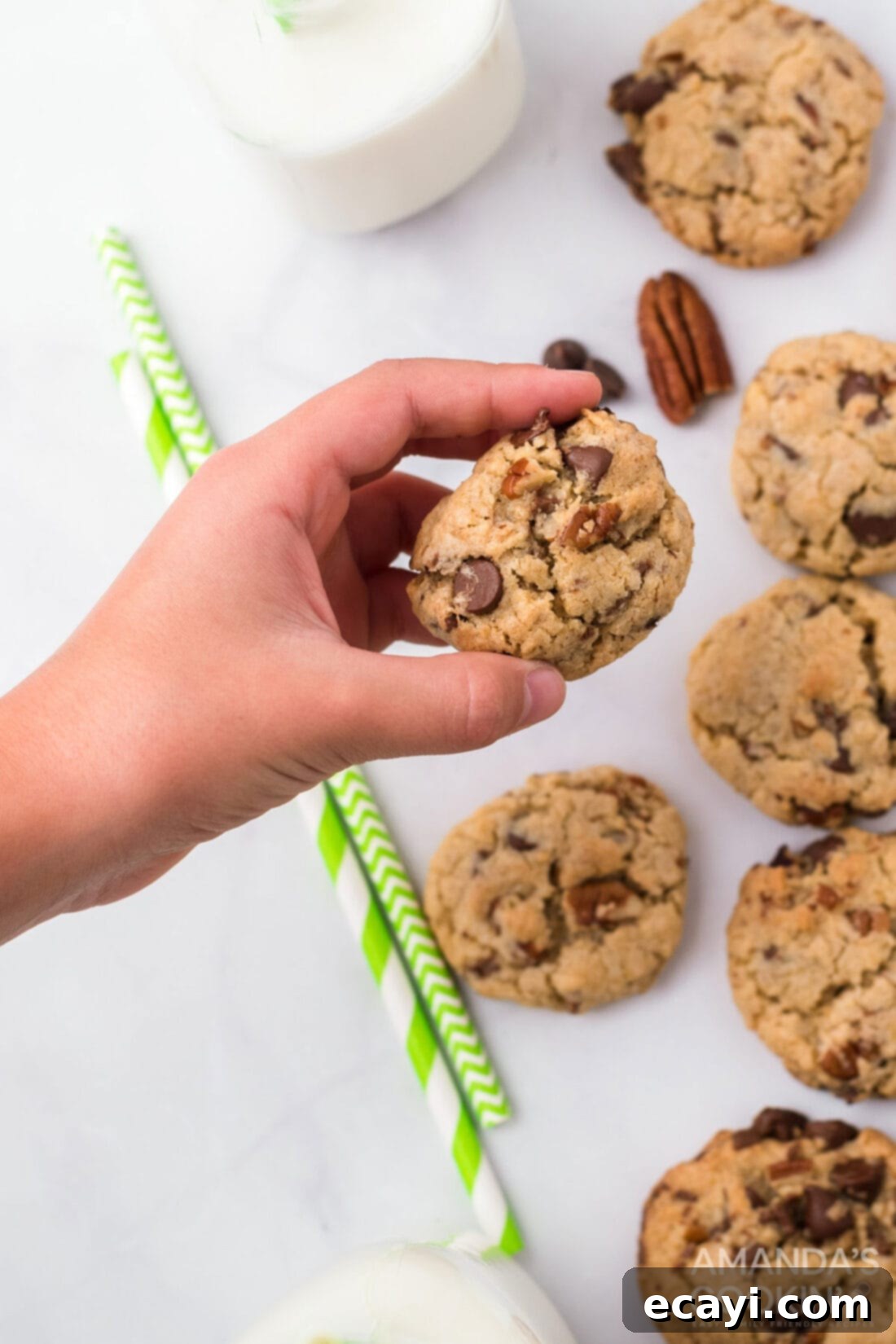 Legendary Neiman Marcus Cookies 5 A hand holding a perfectly baked Neiman Marcus cookie, showing its rich texture and melty chocolate.