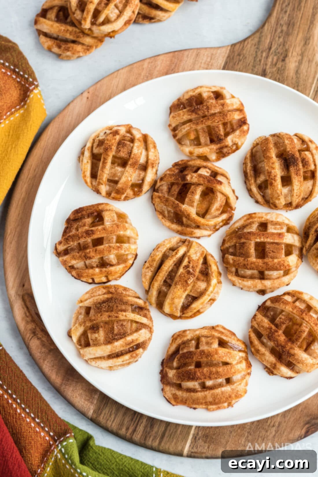Apple Pie Delights 2 golden brown apple pie cookies on a round wooden cutting board, ready to be enjoyed