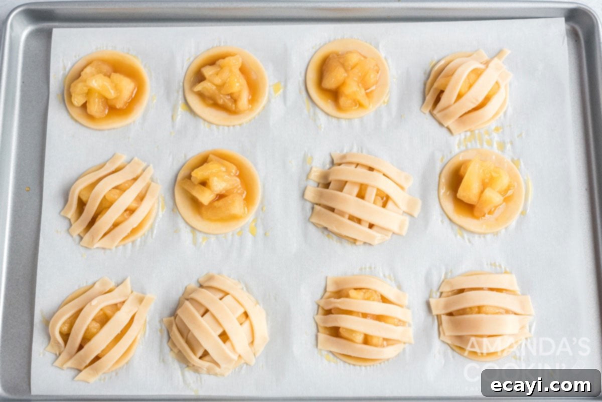 Apple Pie Delights 11 strips of pie dough arranged in a criss-cross pattern over the apple pie cookie fillings