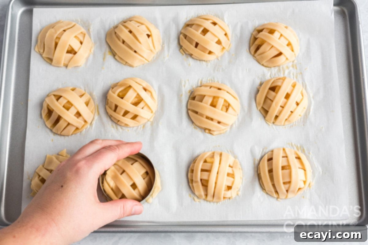 Apple Pie Delights 12 using a cookie cutter to trim excess dough strips from the edges of an apple pie cookie