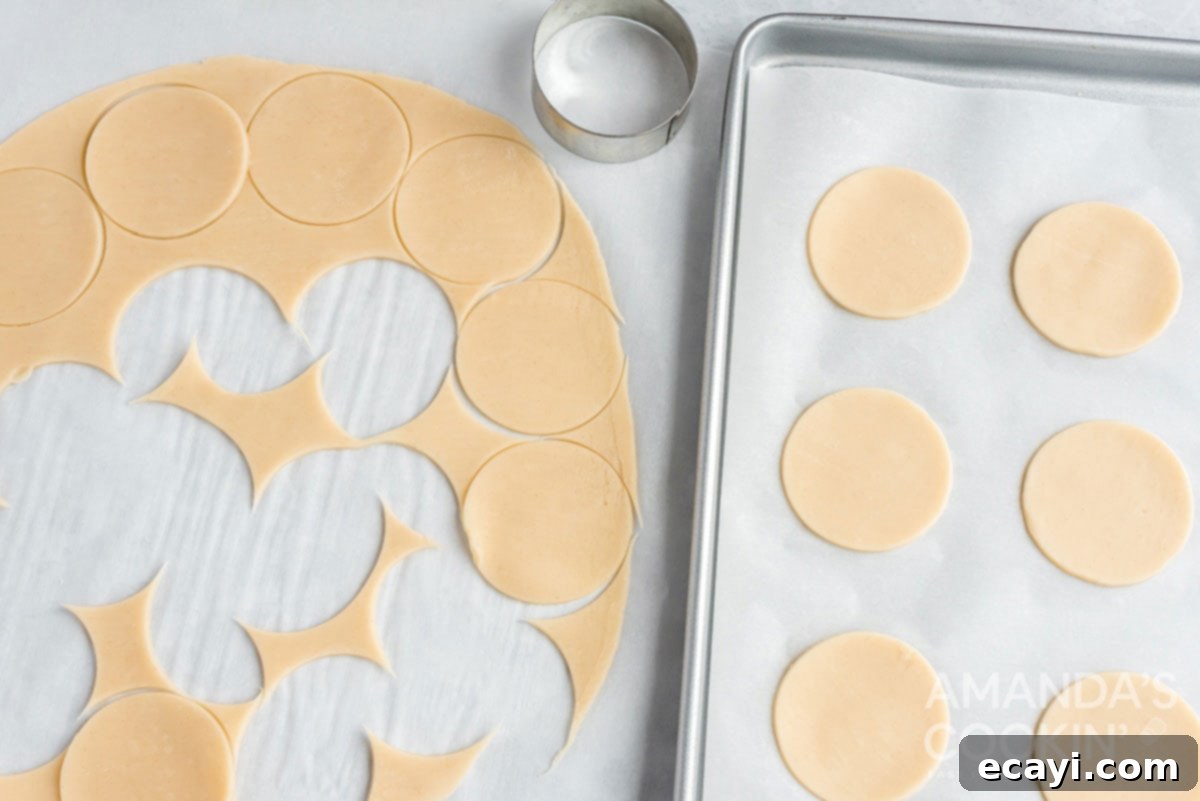 Apple Pie Delights 6 pie dough with circles neatly cut out, forming the bases for the apple pie cookies