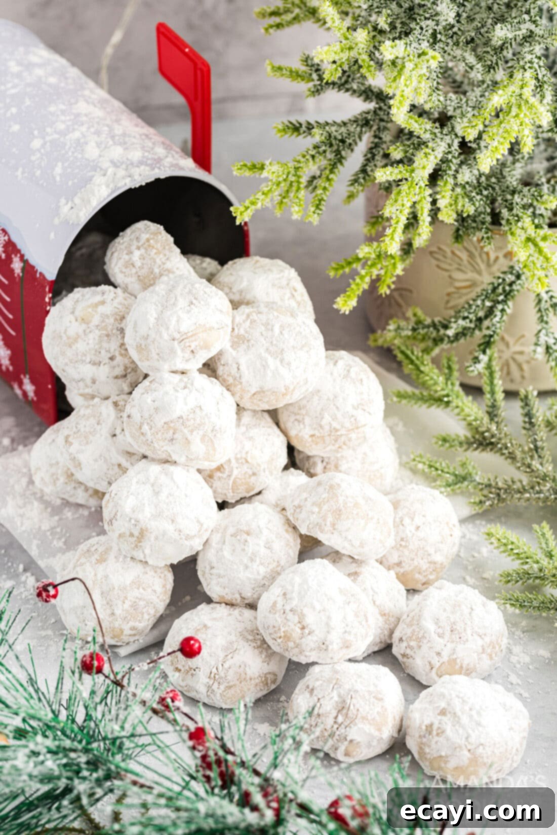 Snowball Cookies 15 A large, inviting pile of freshly baked snowball cookies, generously dusted with fine powdered sugar, ready for serving