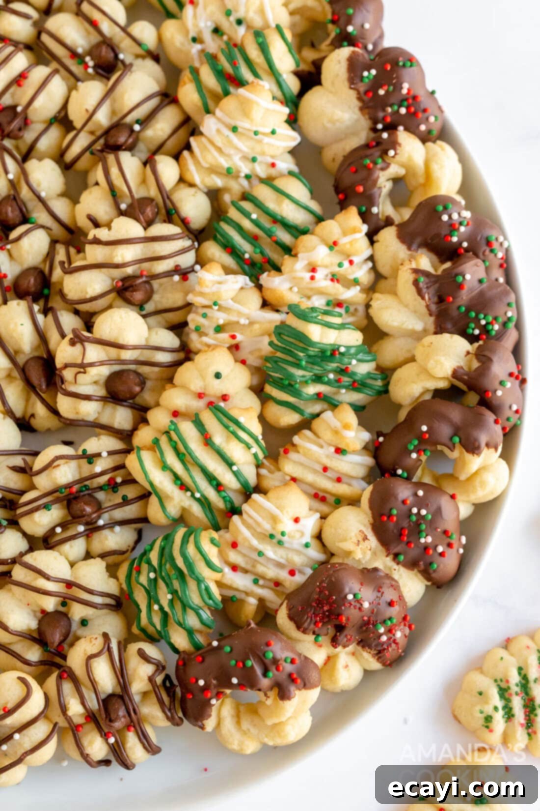 Spritz Cookies 2 A plate filled with beautifully decorated festive Spritz cookies, perfect for holidays.