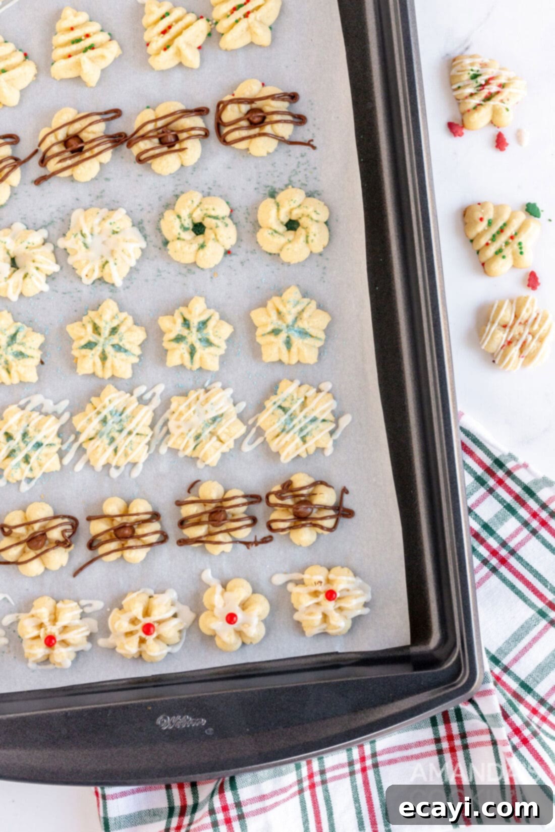 Spritz Cookies 3 A baking sheet fresh from the oven, laden with rows of perfectly shaped Spritz cookies ready for cooling.