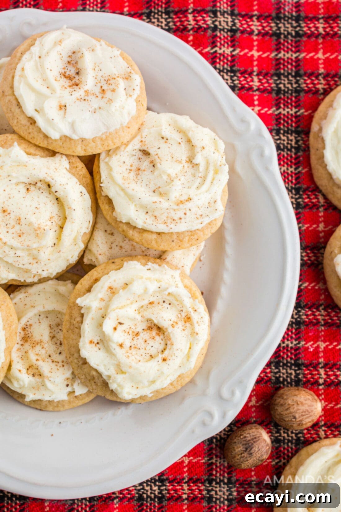 Velvet Eggnog Cookies 2 Plate of perfectly frosted eggnog cookies garnished with nutmeg, ready for holiday celebrations