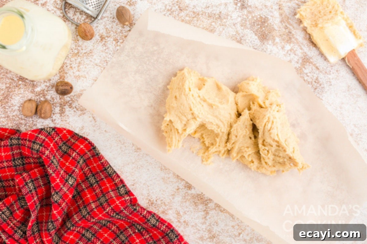 Velvet Eggnog Cookies 6 Sticky eggnog cookie dough being formed into a log on waxed paper