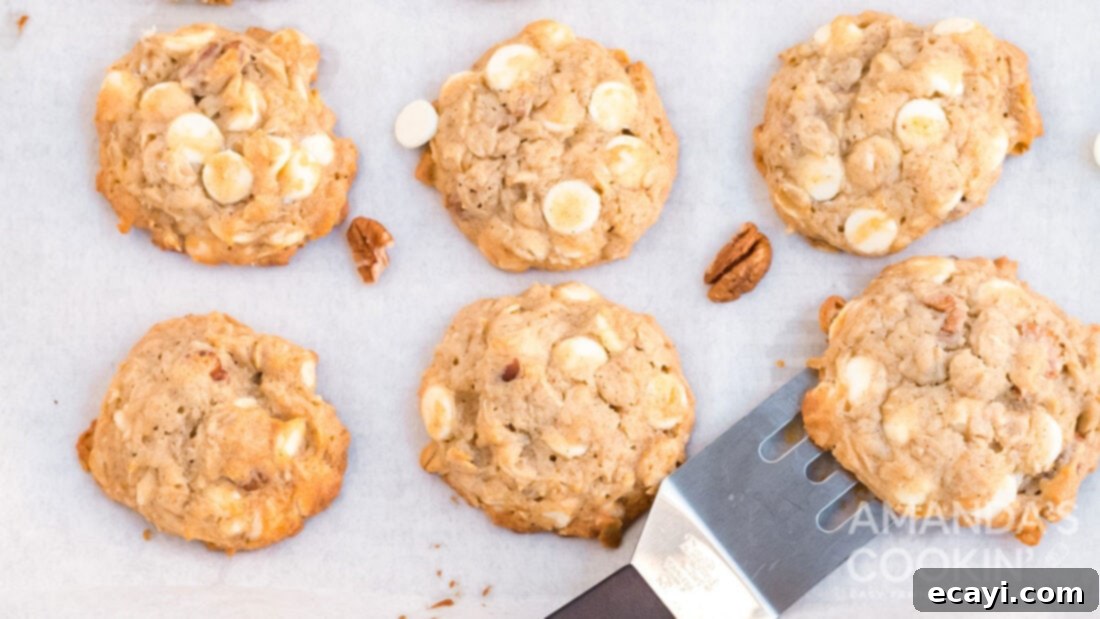 Soft-Baked Banana Cookies 13 A single banana cookie with a spatula underneath, ready to be lifted off the cooling rack