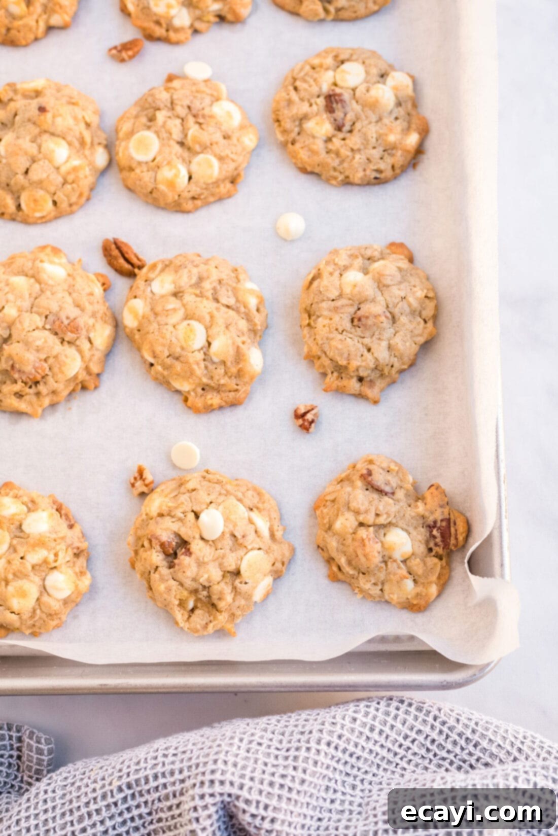 Soft-Baked Banana Cookies 4 Freshly baked banana cookies cooling on a baking sheet after coming out of the oven