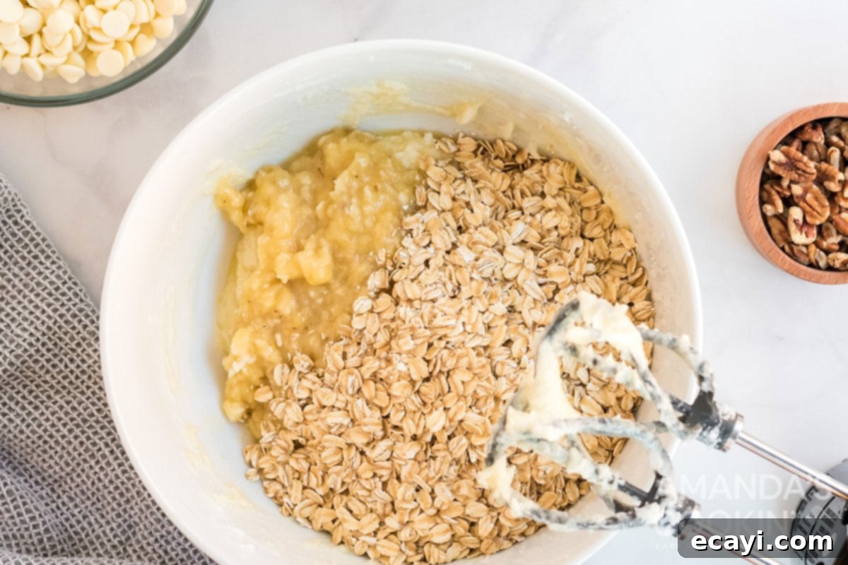 Soft-Baked Banana Cookies 9 Oats being mixed into the banana cookie dough